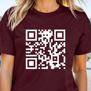 a woman wearing a t - shirt with a qr code on it