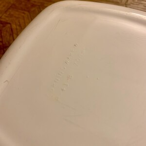 May include: White ceramic bowl with the text "PYREX WARE 4.3 LB 1.95 QT" on the bottom.