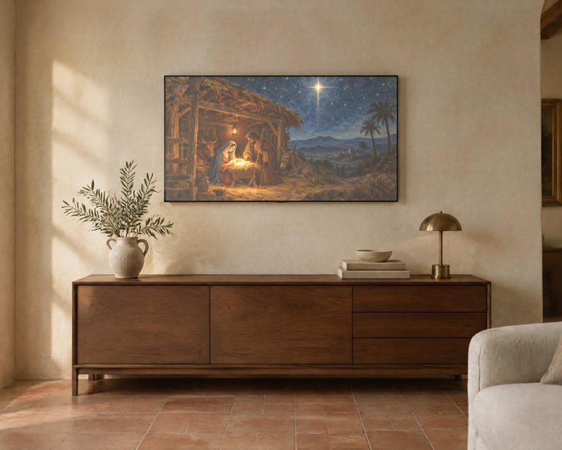 May include: A rectangular wall art print depicting a nativity scene with a glowing star in a dark blue night sky, mounted above a long, dark brown wooden sideboard featuring three drawers and two cabinet doors with a smooth finish.