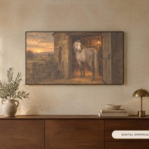 May include: A rectangular wall art print featuring a dappled grey horse standing inside a rustic stone stable at sunset. The scene depicts a golden horizon over a field, with the horse facing the viewer from the open stable doorway.