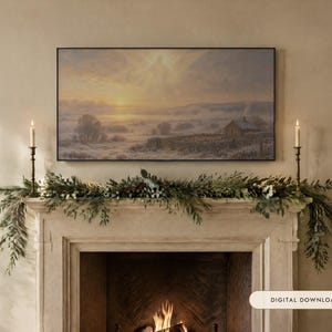 May include: A rectangular landscape painting featuring a snowy countryside scene with a small house, stone walls, and a glowing sunrise, displayed above a fireplace mantel decorated with a green pine garland and two tall brass candlesticks.