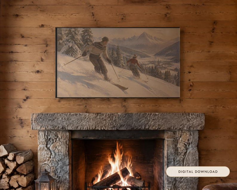 May include: A rectangular framed wall art print featuring a vintage-style painting of two people skiing down a snowy mountain slope with pine trees and distant peaks, displayed above a stone fireplace with a digital download label.