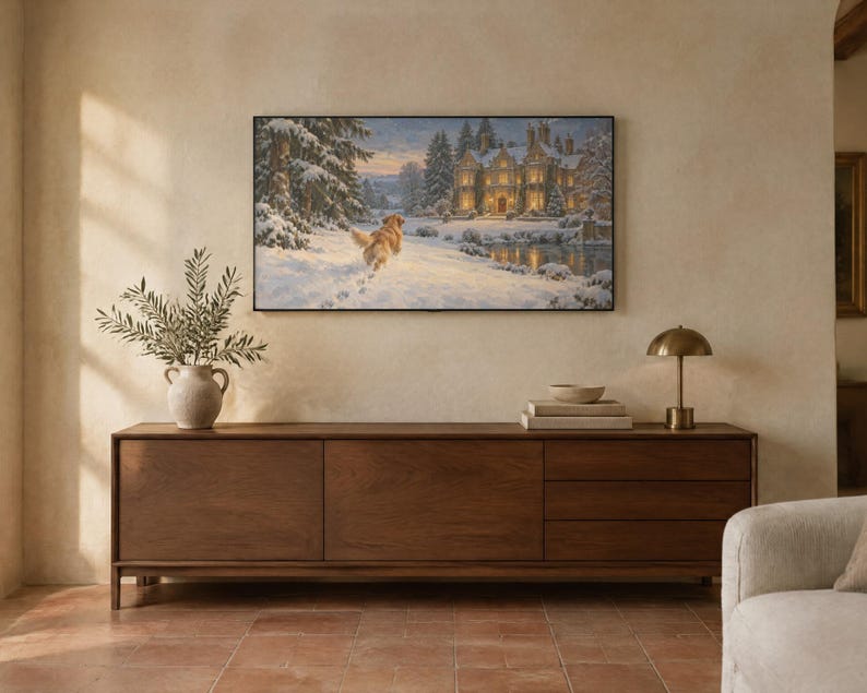 May include: A rectangular wall-mounted television displaying a winter landscape painting of a golden retriever running through snow toward a large, illuminated stone manor house surrounded by snow-covered pine trees and a frozen pond.