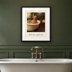May include: A framed wall art print featuring a golden retriever sitting in a white clawfoot bathtub filled with bubbles. The image includes the text "Bath time, apparently" printed in a serif font below the central illustration.