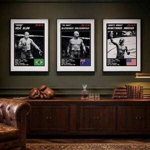 May include: Three framed black and white posters featuring MMA fighters Jos&eacute; Aldo, Alexander Volkanovski, and Demetrious Johnson. Each print includes the fighter's nickname, record, physical stats, birth date, and their respective national flag.