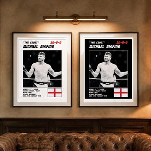 May include: Two framed posters featuring a black and white photograph of Michael Bisping. The text reads "The Count", "30-9-0", "Michael Bisping", and includes his stats: height 6' 1", reach 75.5", stance orthodox, and DOB 28th February 1979.
