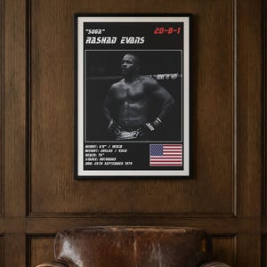 May include: A black and white framed poster featuring a photograph of Rashad Evans with the text "SUGA" RASHAD EVANS, 20-8-1, and his physical stats including height 6'0", weight 205lbs, reach 75", stance orthodox, and DOB 25th September 1979.