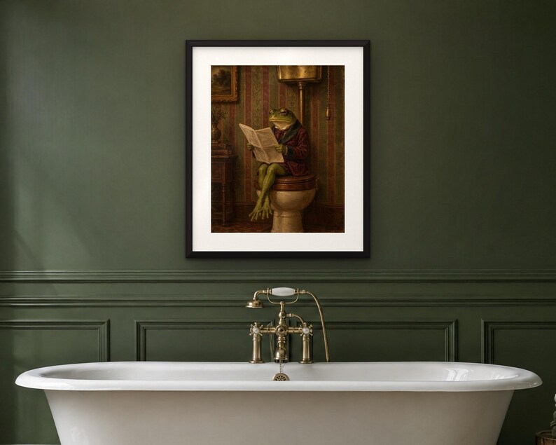 May include: A framed wall art print featuring a green frog wearing a dark red jacket, sitting on a toilet and reading a newspaper. The scene is set in a room with striped wallpaper, rendered in muted tones of brown, green, and cream.