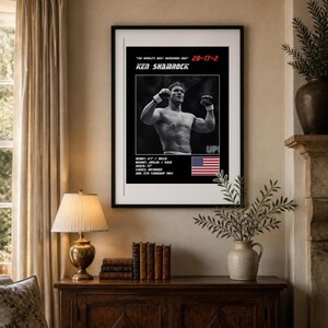 May include: A framed poster featuring a black and white photograph of Ken Shamrock with his arms raised. Text includes "The World's Most Dangerous Man", "28-17-2", "Ken Shamrock", and stats: "Height: 6'1", "Weight: 205lbs", "Reach: 73", "Stance: Orthodox", "DOB: 11th February 1964", and a US flag.