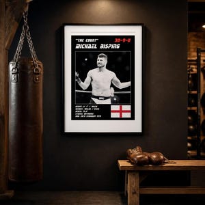 May include: A framed poster featuring a black and white photograph of Michael Bisping with the text "The Count" 30-9-0, Michael Bisping, height 6'1" / 185cm, weight 185lbs / 84kg, reach 75.5", stance orthodox, DOB 28th February 1979, and an English flag.