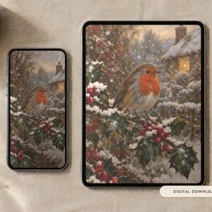 May include: A smartphone and a tablet displaying a digital illustration of a robin perched on a snow-covered holly branch with red berries, set against a winter cottage background. The text Digital Download is visible on a small rectangular label.