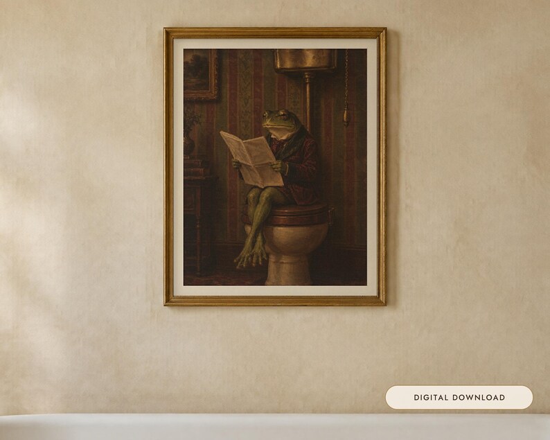 May include: A framed wall art print featuring an anthropomorphic green frog wearing a dark jacket, sitting on a toilet while reading a newspaper. The scene is set in a room with striped wallpaper and a vintage-style toilet fixture.