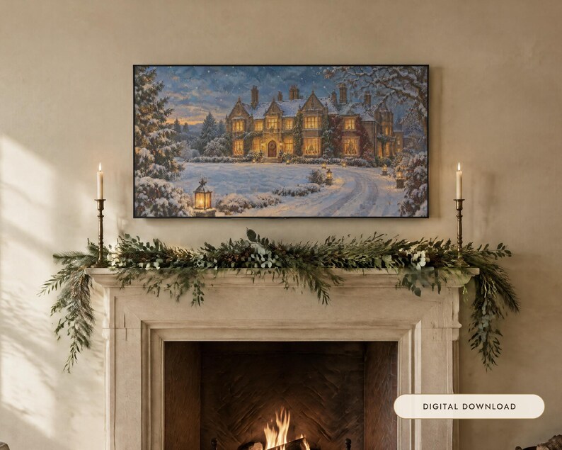 May include: A rectangular wall art print depicting a large manor house covered in snow at twilight, displayed above a fireplace mantel decorated with a green pine garland and two tall brass candlesticks with lit white taper candles.