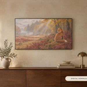 May include: A rectangular wall art print featuring a fox sitting in a misty autumn forest with golden sunlight filtering through the trees. The scene includes reddish-brown ferns, mossy ground, and a dense woodland background in a black frame.