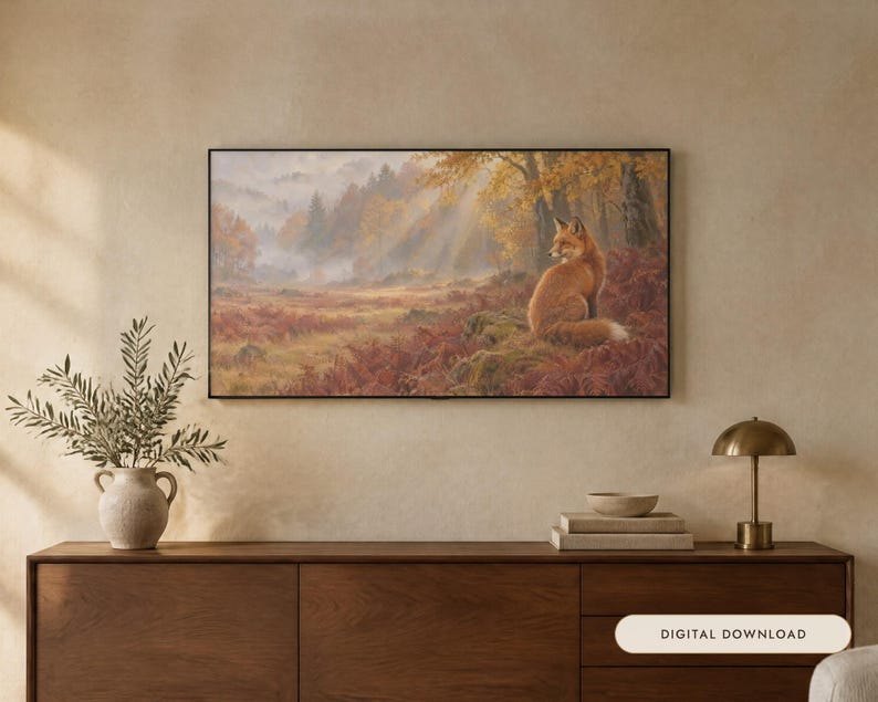 May include: A rectangular wall art print featuring a fox sitting in a misty autumn forest with golden sunlight filtering through the trees. The scene includes reddish-brown ferns, mossy ground, and a dense woodland background in a black frame.