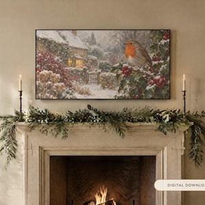 May include: A rectangular wall art print featuring a winter scene with a robin perched on a holly branch covered in snow, set against a cottage background. The print is displayed above a fireplace mantel decorated with greenery and candles.