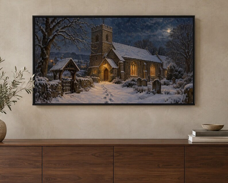 May include: A rectangular framed wall art print depicting a stone church at night during winter. The scene features snow-covered grounds, a path with footprints leading to the entrance, glowing yellow windows, and a dark, starry sky.