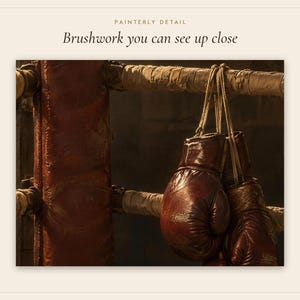 Pode incluir: Um par de luvas de boxe de couro castanho escuro penduradas num poste de ringue almofadado. O texto PAINTERLY DETAIL e Brushwork you can see up close &eacute; vis&iacute;vel no topo da imagem, contra um fundo quente e pouco iluminado.