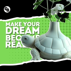 May include: White ceramic turtle vase with a green background and white text that reads "Make your dream become real". The vase is filled with white flowers and green leaves.