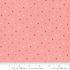 May include: Pink fabric with a white and red polka dot pattern. The fabric is shown with a ruler measuring 7 inches.