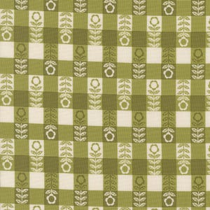 May include: A fabric with a repeating pattern of white flowers and leaves on a green and off-white checkered background. The floral design is vertical, creating a structured, symmetrical look. The fabric has a vintage, retro aesthetic.