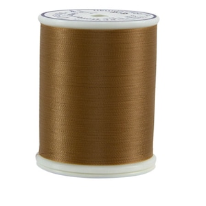 May include: A spool of brown thread.