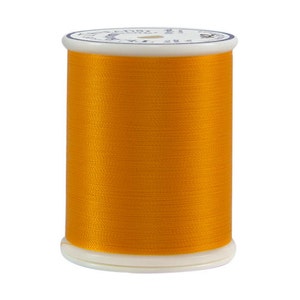 May include: A spool of bright orange thread.