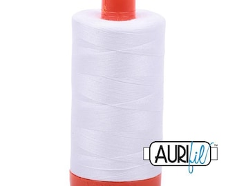 May include: A white spool of Aurifil thread with an orange top and base. The thread is tightly wound around the spool, creating a cylindrical shape. The Aurifil logo is visible on the side.