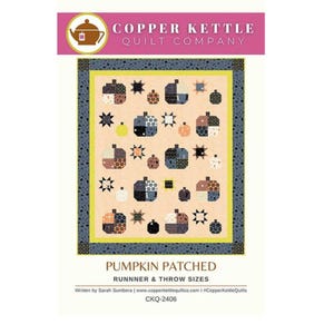 May include: A quilt pattern titled Pumpkin Patched by Copper Kettle Quilt Company. The design features a light peach background with various pumpkin and star motifs in black, grey, orange, and white patterns, framed by a dark grey border.