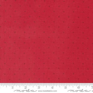 May include: Red fabric with a small, white polka dot pattern. The fabric is shown with a ruler for scale.