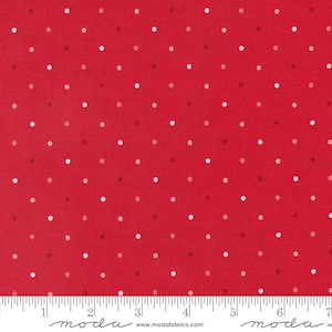 May include: Red fabric with a polka dot pattern. The dots are in shades of white, light red, and dark red. A ruler is at the bottom of the image, with the word "moda" printed on it.