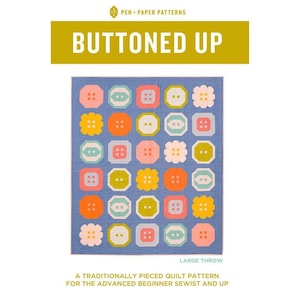 May include: A blue quilt with a pattern of colorful button shapes. The buttons are in various colors, including pink, orange, yellow, and white. The text "BUTTONED UP" is displayed above the quilt. The quilt is a large throw.