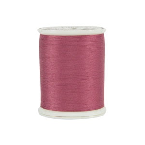 May include: A spool of pink thread.