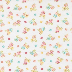 May include: White fabric with a repeating floral pattern. The design features clusters of small flowers in pink, yellow, and blue, interspersed with individual blossoms. The overall effect is a delicate, springtime aesthetic.