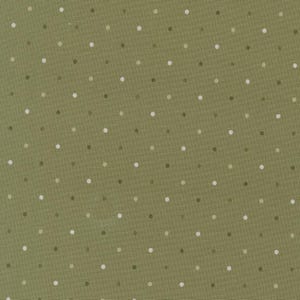 May include: Olive green fabric with a repeating pattern of small, evenly spaced polka dots in white and shades of green. The fabric has a slightly textured appearance, suggesting a woven material. This design is suitable for quilting, apparel, or home decor projects.