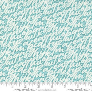 May include: A teal blue fabric with a white alphabet pattern. The letters are written in a casual, handwritten style. The fabric is marked with a ruler in inches.