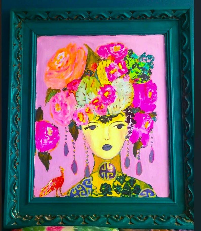 May include: A vibrant painting of a woman with a floral headdress and a peacock. The artwork features a pink background, a teal frame, and a yellow face. The woman's attire includes a yellow collar with a decorative emblem and a patterned green and blue top. The painting is colorful and eye-catching.