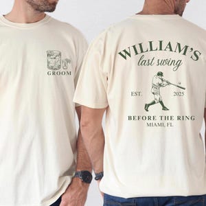 May include: Two white t-shirts with text and graphics. The left shirt says "Groom" and has a drawing of a cocktail glass. The right shirt says "William's last swing" and has a drawing of a baseball player with the text "Est. 2025" and "Before the Ring Miami, FL".