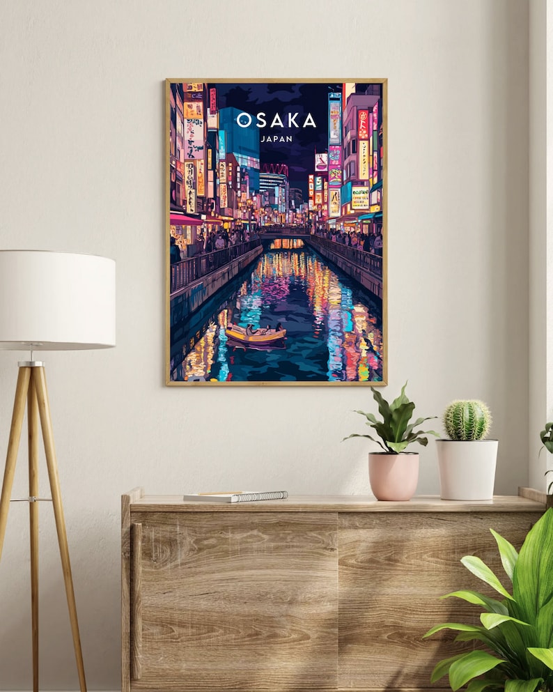 May include: A colorful illustration of a cityscape at night in Osaka, Japan. The image features a canal with a boat and reflections of the city lights. The text "OSAKA JAPAN" is displayed at the top of the image.