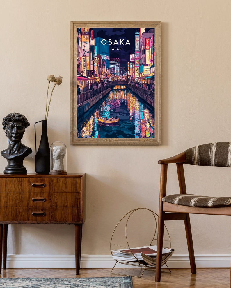 May include: A framed poster with a colorful illustration of a canal in Osaka, Japan at night. The poster has the text "OSAKA JAPAN" at the top.
