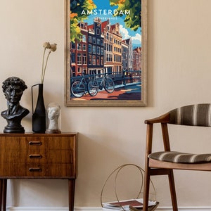May include: A vintage-style poster with a colorful illustration of Amsterdam, Netherlands. The poster features a view of a canal with traditional Dutch houses and bicycles.
