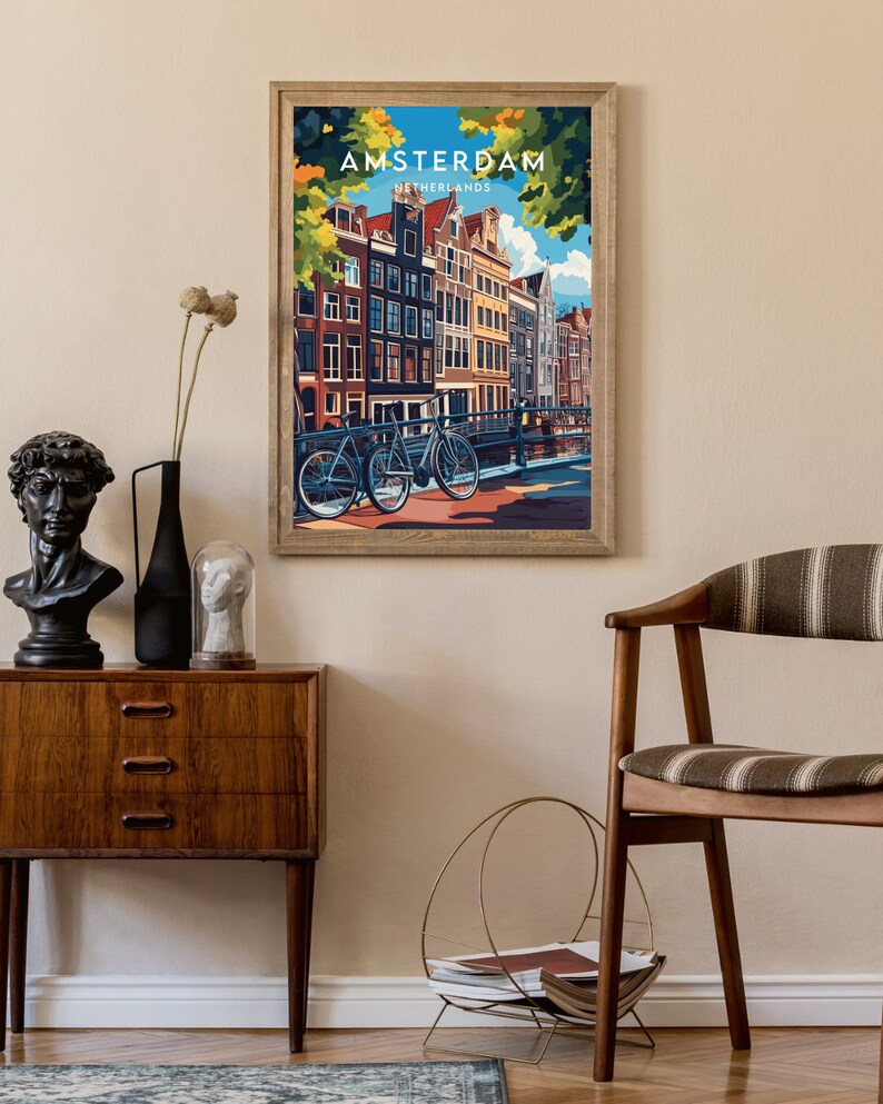May include: A vintage-style poster with a colorful illustration of Amsterdam, Netherlands. The poster features a view of a canal with traditional Dutch houses and bicycles.