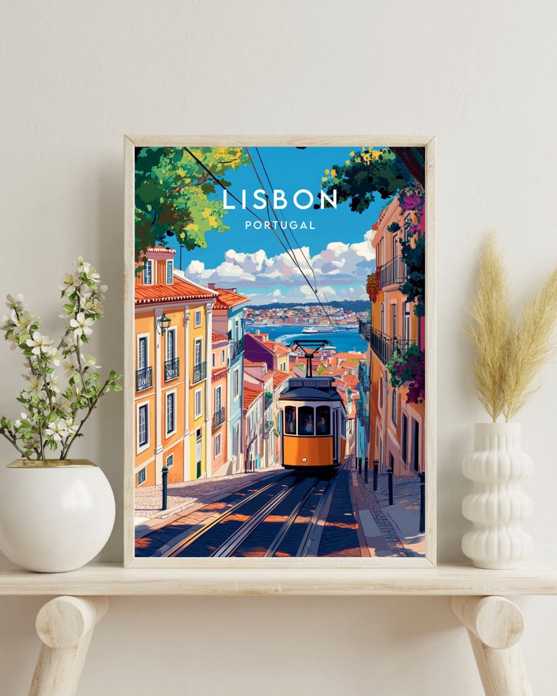 May include: A vintage travel poster featuring a yellow tram traveling up a steep hill in Lisbon, Portugal. The poster has a blue sky with white clouds and colorful buildings on either side of the tram.