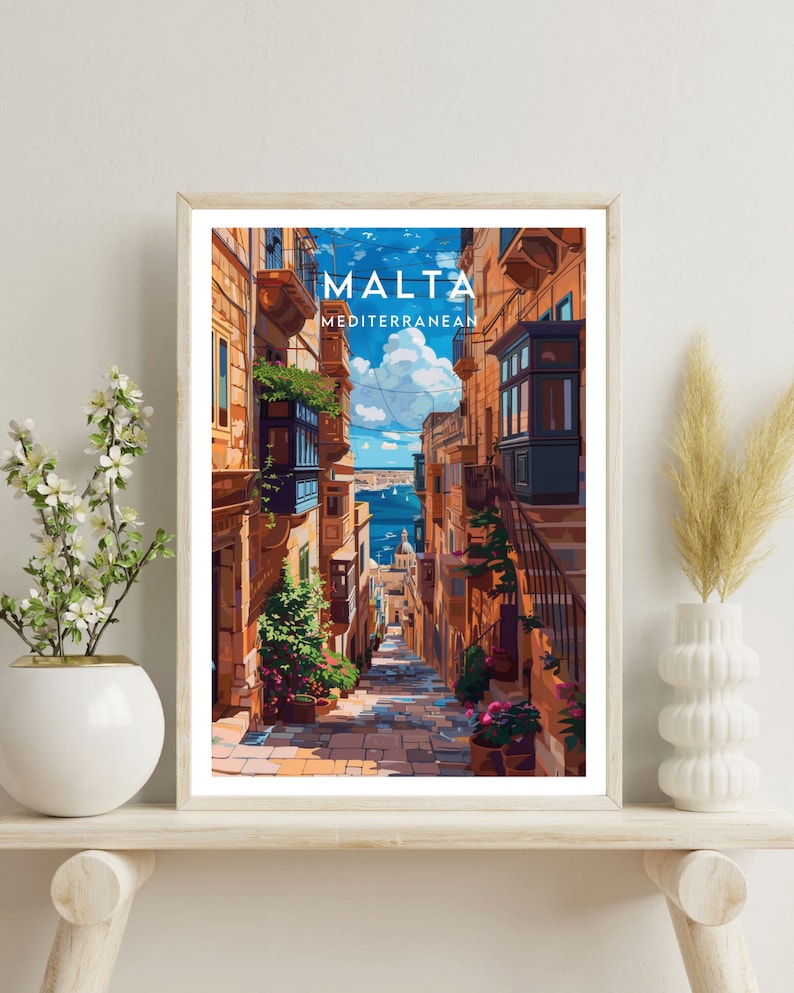 May include: A colorful illustration of a narrow street in Malta, with buildings on either side and a view of the Mediterranean Sea in the distance. The text "MALTA MEDITERRANEAN" is at the top of the image.