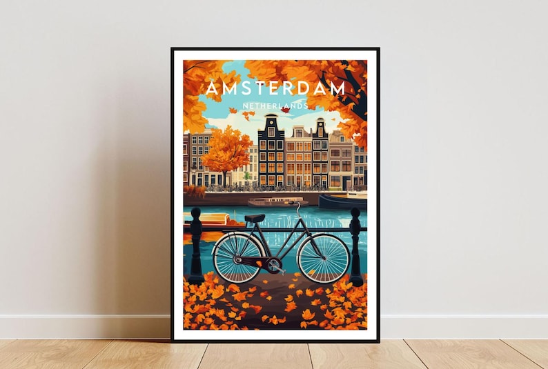 May include: A vintage travel poster with a colorful illustration of Amsterdam, Netherlands. The poster features a bicycle parked on a bridge with a canal and buildings in the background. The text "AMSTERDAM NETHERLANDS" is printed on the poster.