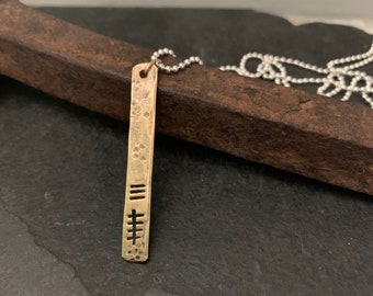 Distressed Bronze Pendant with Roman Numeral Date or Hatch Marks