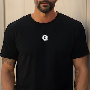 May include: A black t-shirt with a white Bitcoin logo on the front.