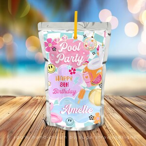 May include: A clear juice pouch with a yellow straw, featuring a "Pool Party" theme. The design includes a disco ball, flamingo, and the text "Happy 8th Birthday Amelie". The pouch is decorated with flowers and a smiley face.