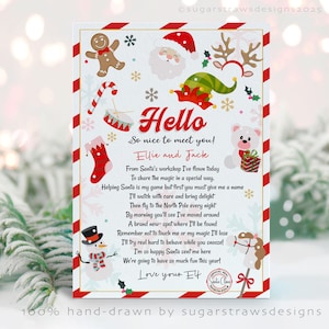 May include: A festive Christmas card with a red and white striped border. The card includes illustrations of Santa Claus, an elf hat, reindeer antlers, a gingerbread man, and a snowman. Text on the card reads "Hello" and a poem, with the words "Ellie and Jack".