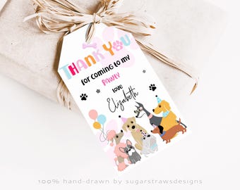 May include: A gift tag with the text "Thank You for coming to my PAWLY" and "Love Elizabeth". The tag features illustrations of various dog breeds, paw prints, and balloons. The tag is tied to a wrapped gift with a raffia bow.